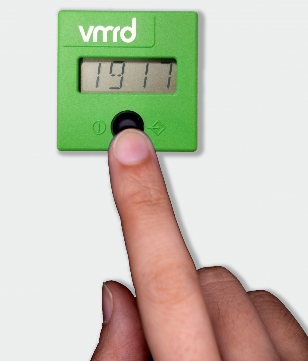 finger on button of VMRD reader showing numerical results 